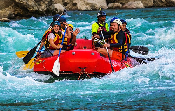 Whitewater rafters navigating Class III rapids